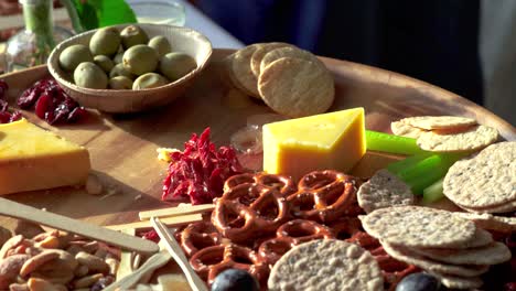 food being picked off charcuterie board at event