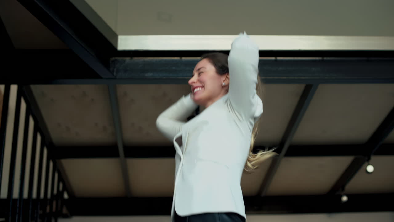 A smiling woman in business attire being enthusiastic expressing success and optimism