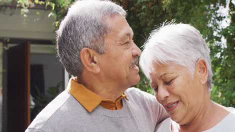 Happy-senior-diverse-couple-embracing-in-garden