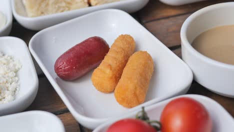 turkish breakfast with sausage, cheese, tomatoes and bread