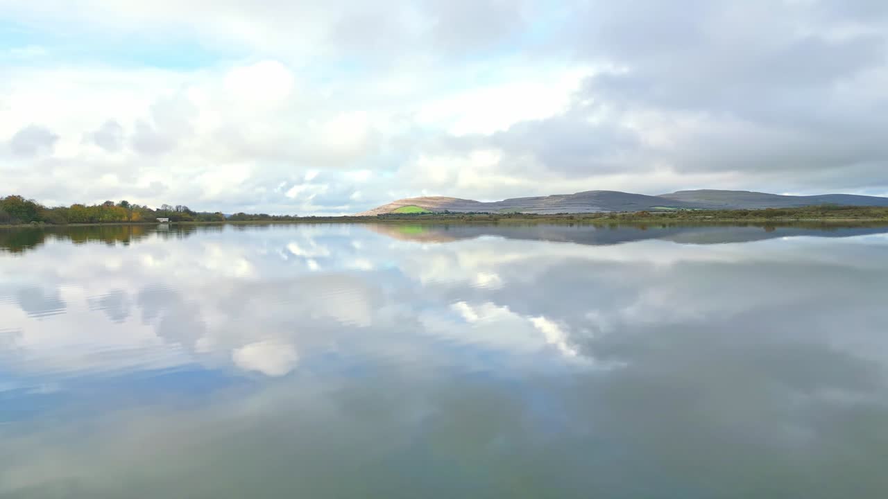 Serene Burren lake view with cloudy sky reflection, Ireland