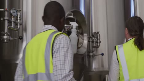 Caucasian-and-African-American-man-working-in-a-microbrewery