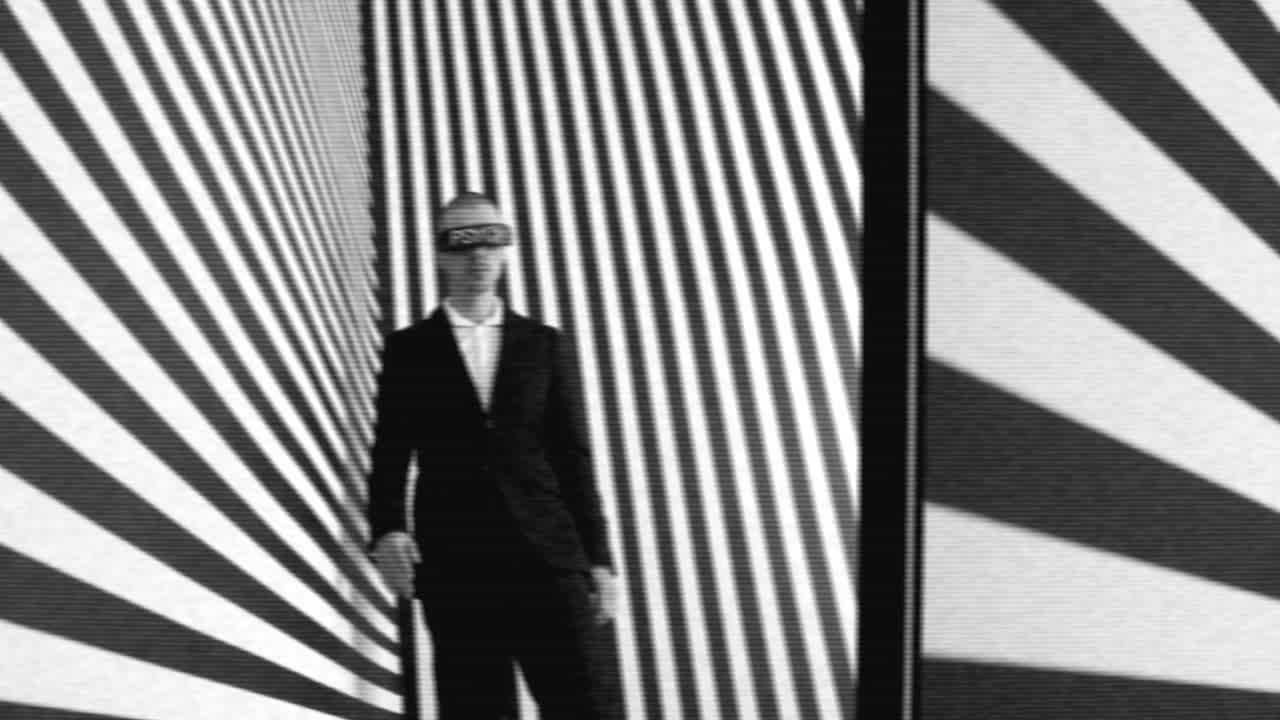 Man in a Suit in a Black and White Optical Illusion Tunnel