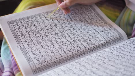 close-up of a muslim woman is reciting the koran reading al qur'an