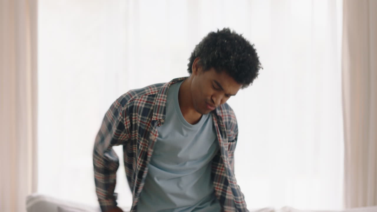 happy young man dancing at home having fun celebrating with funny dance moves enjoying freedom on weekend 4k footage