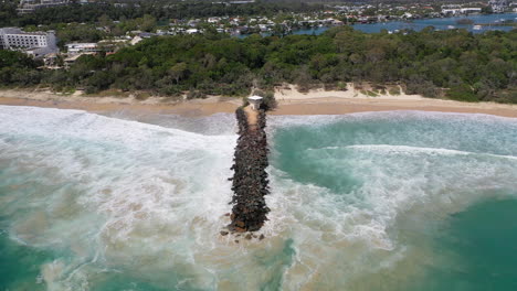 aerial view of an australian wave breaker and lifeguard station with waves crashing