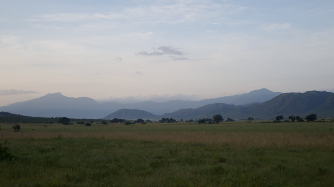 Panning right across national park and mountain landscape in Africa