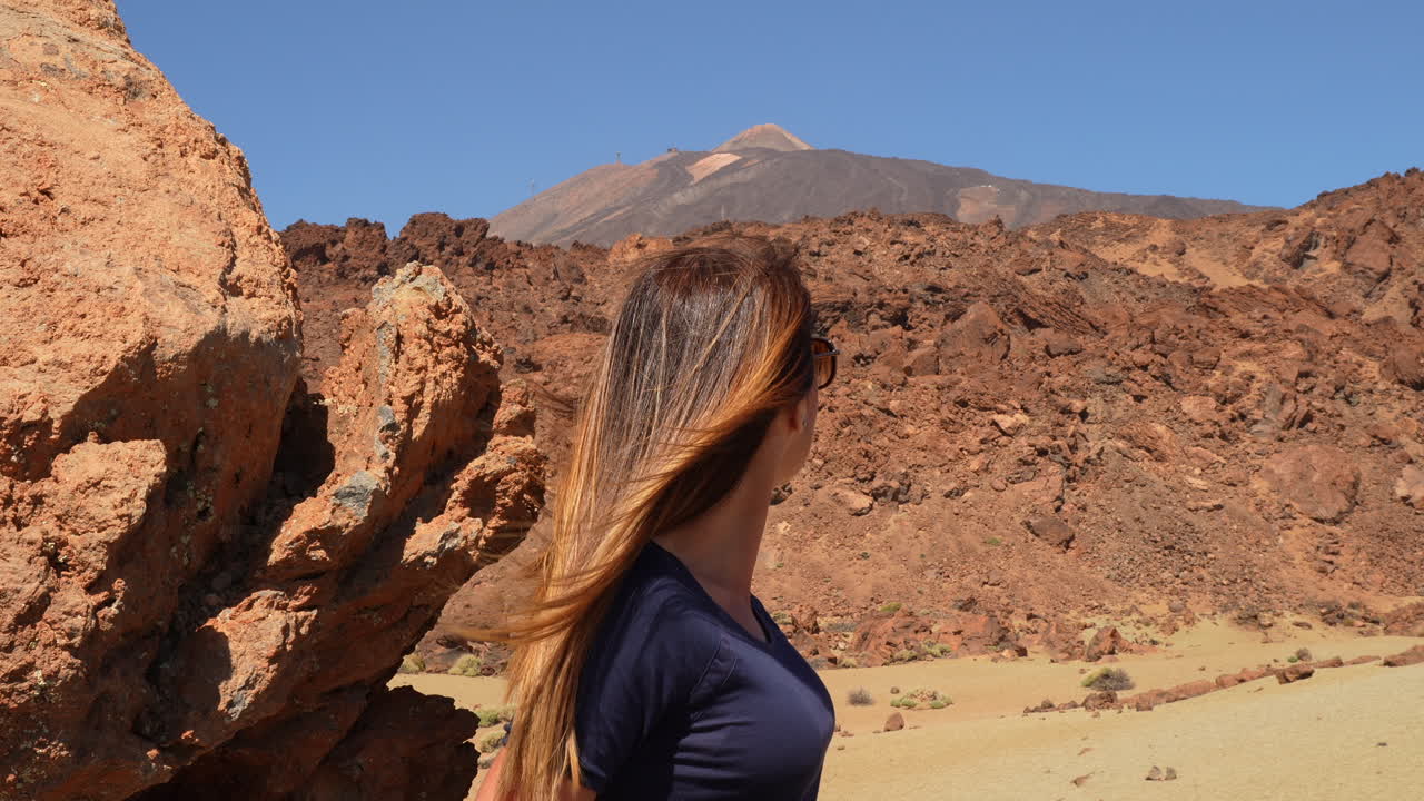 Tourist observing volcano Teide in Teide National Park, Tenerife