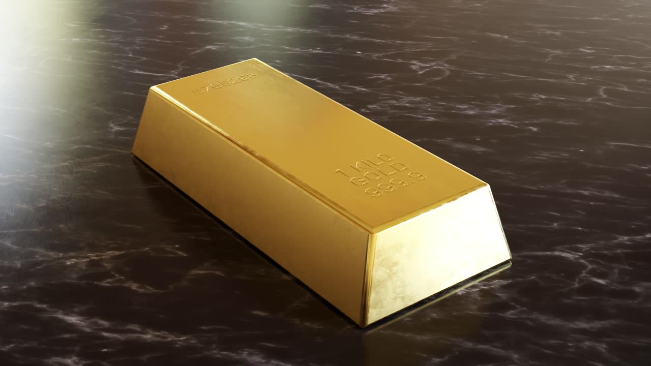 Shining gold bar placed on marble table
