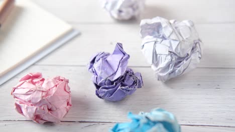 crumpled paper balls on a desk