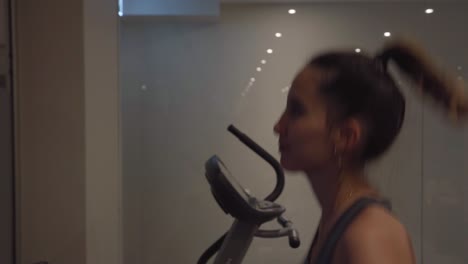 young woman running on a treadmill inside a gym, concept for discipline and motivation