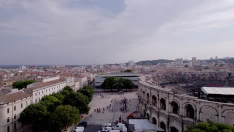 Long-retreat-in-aerial-view-to-reveal-the-center-of-Nîmes,-the-arenas,-the-Roman-museum
