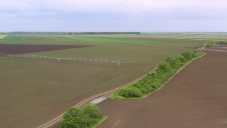 sprinkler irrigation - aerial view of a large-scale pivot spray irrigation system on countryside field