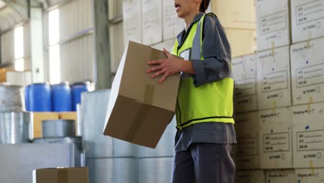 Female-worker-suffering-from-back-pain-while-holding-heavy-box-4k