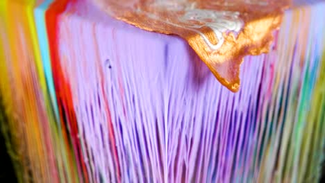 multicolored ink paint slowly flows from the cube underwater