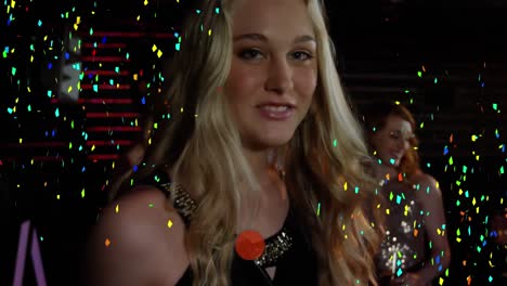 Colorful-confetti-falling-over-portrait-of-caucasian-woman-partying-at-a-bar