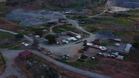 drone video showcases expansive abuja quarry with rugged terrain, vibrant earth hues, and machinery under twilight sky, capturing industrial ambiance and landscape beauty in nigeria, africa