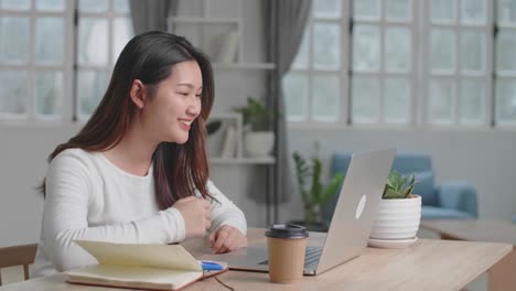 pretty girl having video call on laptop computer at home , video in 4k