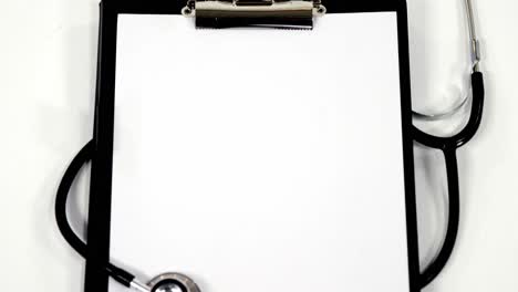 Stethoscope-and-clipboard-with-white-blank-paper