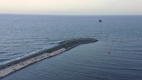 Breakwater-pier-at-Haina-port-and-ship-in-background,-Dominican-Republic