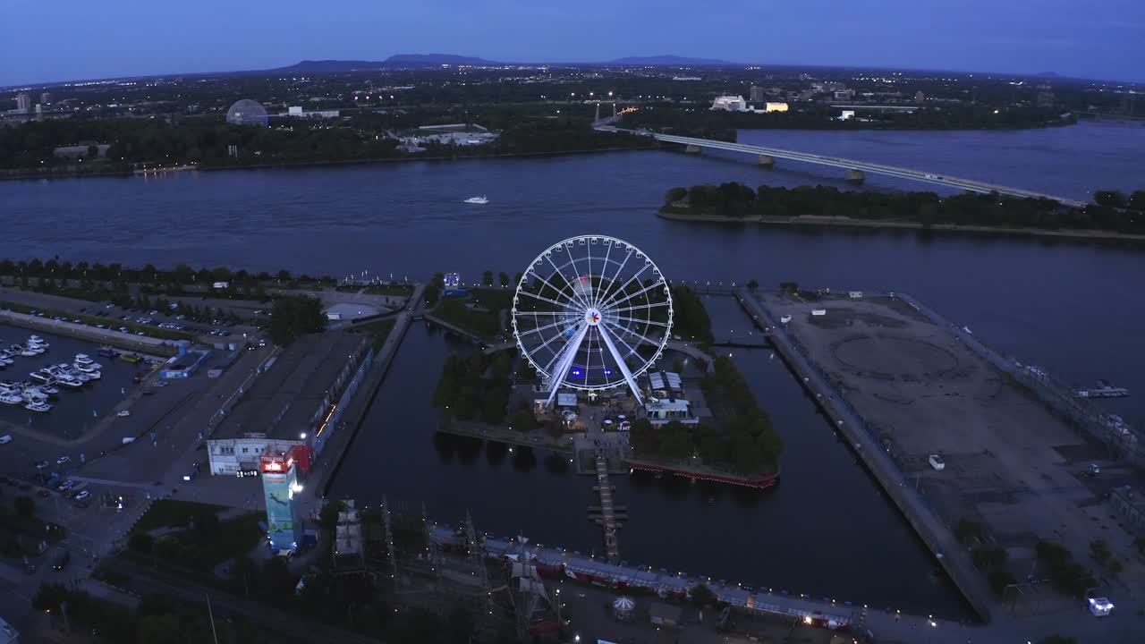Aerial shot of Montreal's Old Port with the Ferris wheel in view, showcasing the vibrant waterfront and historic architecture. Perfect for capturing the essence of the city.