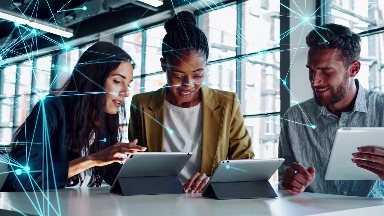 High-angle video of three people using tablets, overlaid with digital network lines