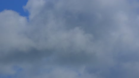 Cumulonimbus-clouds-close-up-with-blue-sky-appearing-and-disappearing