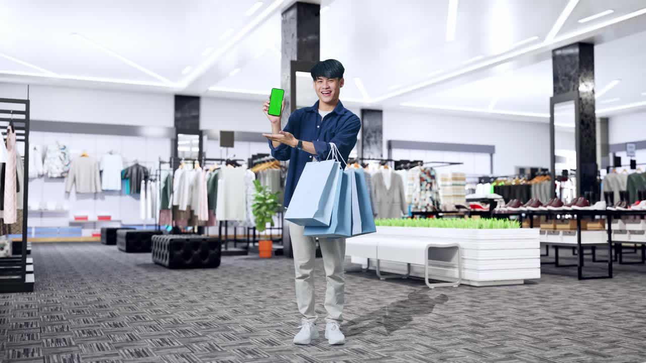 쇼핑하고 쇼핑몰에서 녹색 화면 휴대전화를 들고 있는 남자