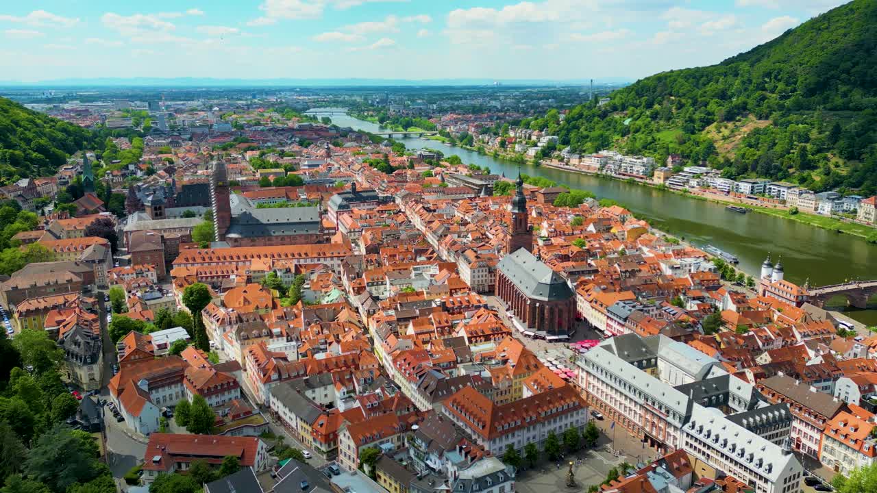4K Aerial Drone Video of Historic Heiliggeistkirche Church in downtown Heidelberg, Germany on the Neckar River
