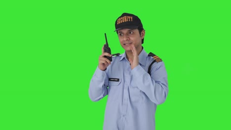 Indian-security-guard-giving-instructions-on-walkie-talkie-Green-screen