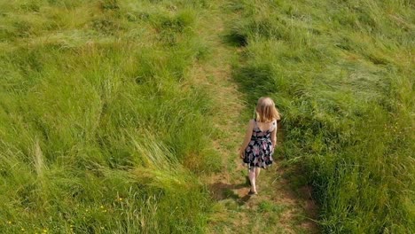 woman walking on green field 4k