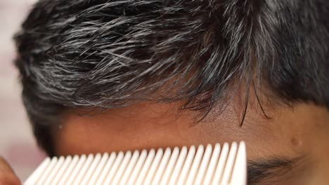 close-up of a man getting his hair cut