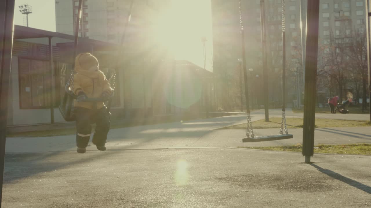 Child playing on a swing set in the park