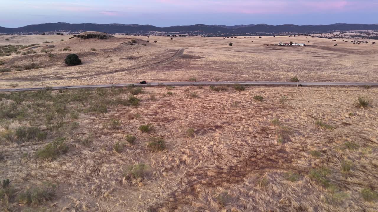 Aerial drone footage flying over dry fields and hills near Cote, Andalusia, southern Spain