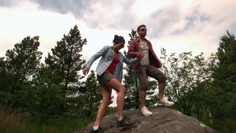 Athletic-couple-reaching-the-summit-and-admiring-the-view