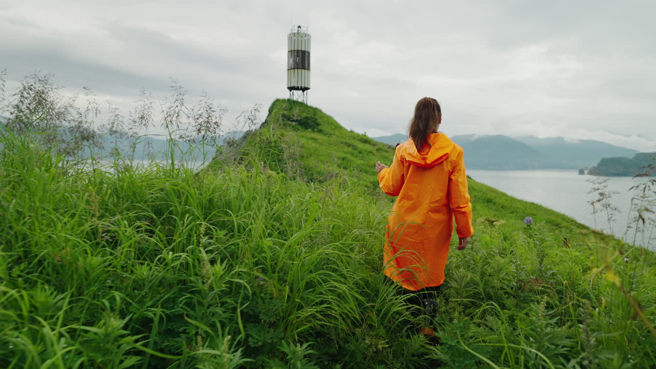 Woman Hiking on a Coastal Hill