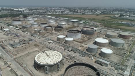 Aerial-footage-of-a-large-scale-Oil-refinery-with-smoke-stacks-and-petroleum-storage-tanks