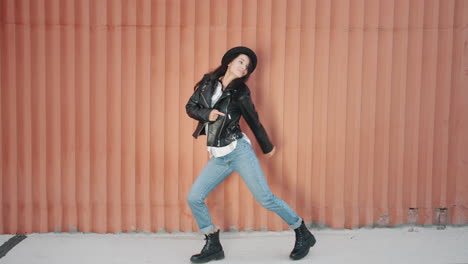 stylish woman dancing in urban setting