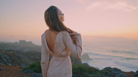 seductive girl looking camera attracting hand at evening sunset hill portrait