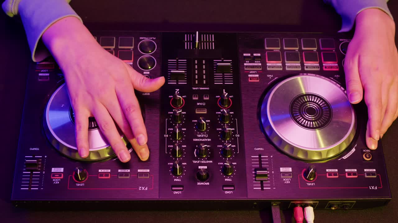 DJ with headphones and sunglasses playing music on festival in night club. Techno musician performing at nightclub for concert crowd of people, city bar.