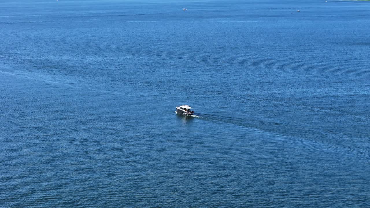 Luxury motor boat in deep blue water, aerial panoramic view