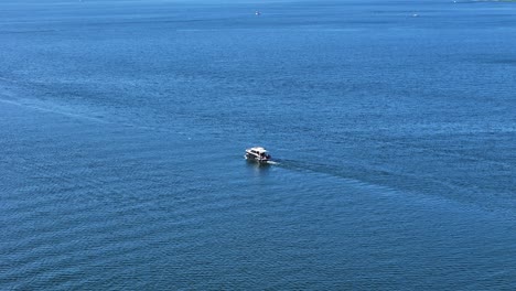 luxury motor boat in deep blue water, aerial panoramic view