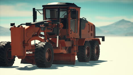 road grading machine on the salt desert road