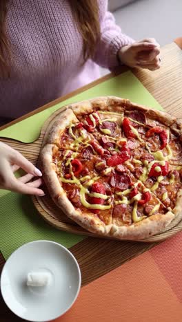 woman eating pizza in a restaurant