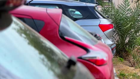 multiple modern vehicles parked in an outdoor urban lot. shallow depth of field with vibrant colors. ideal for traffic, transportation, and city infrastructure themes.