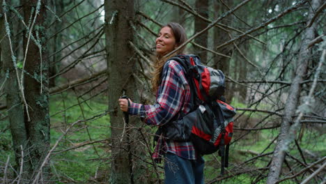 Tourist-standing-in-summer-forest.-Girl-taking-rest-in-woods-during-hike