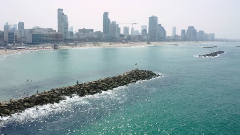 aerial capture of the tel aviv coast with buildings in the background