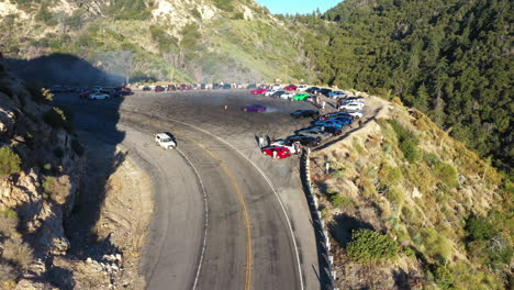muscle and sports cars doing doughnuts and burnouts with a car club in the angeles national forest in southern california