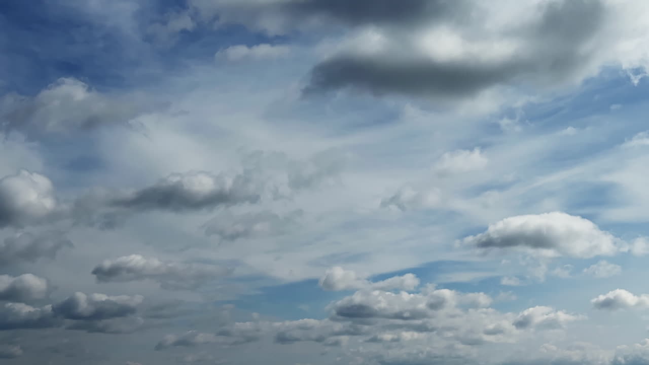 Quick movement and transformation of the grey clouds in the atmosphere. Formation of rains in the sky. Timelapse.