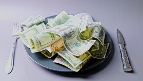 united states dollars served on the plate with fork and knife
